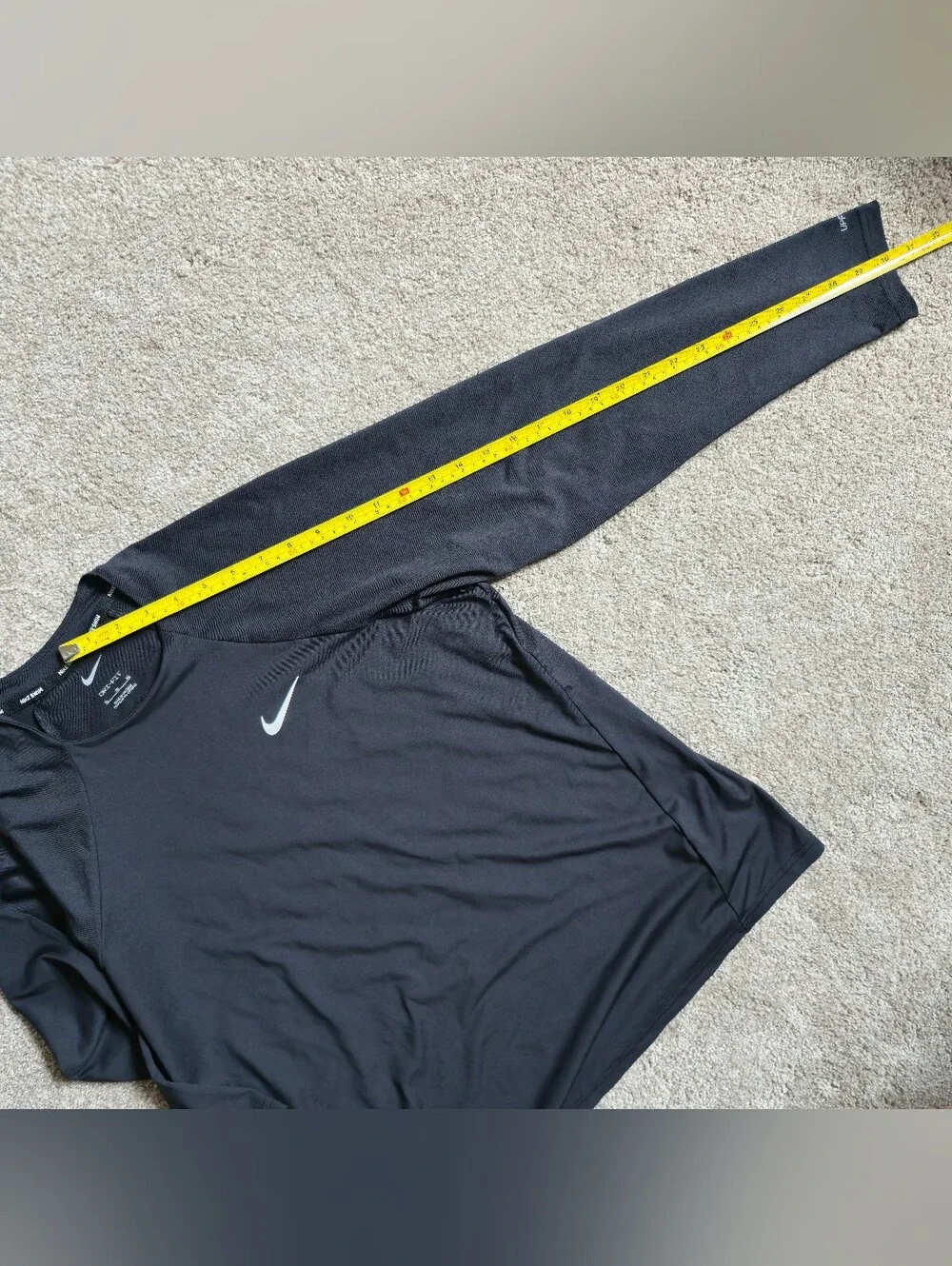 Nike Swim Dri-FIT long-sleeve Rashguard features a classic athletic crewneck